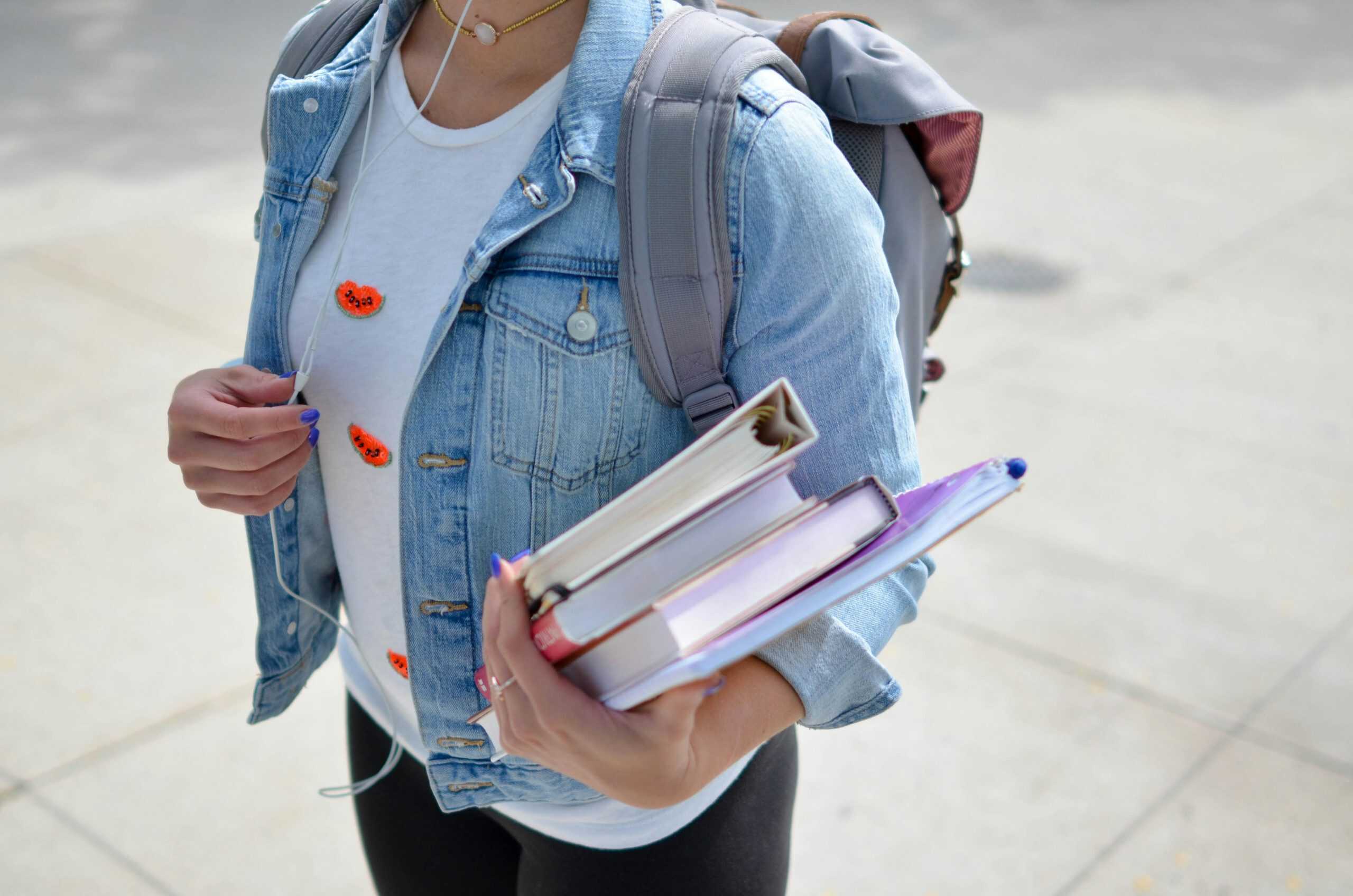 Student carrying books and backpack for college, modern education, university student with study materials, academic success, learning and knowledge concept, BPA Property relevance.