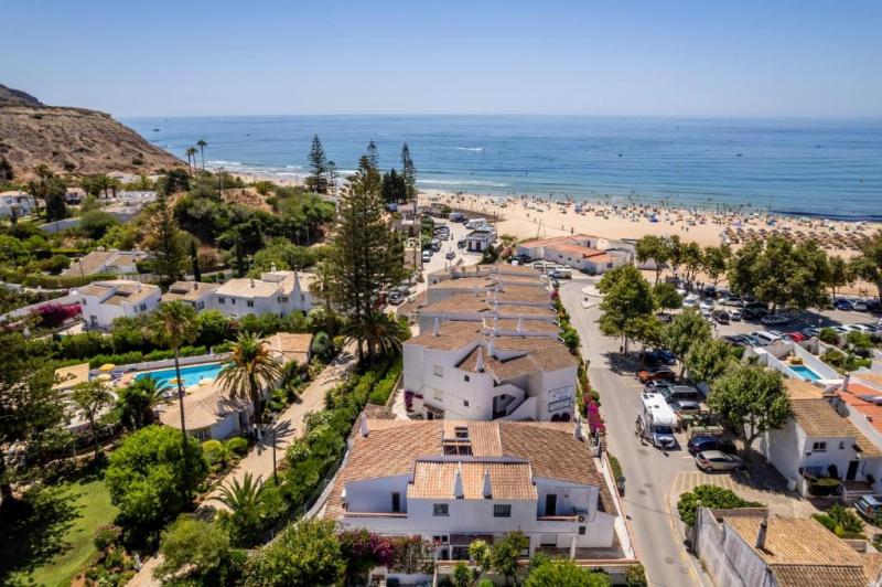 Drone overview of street containing villas in Lagos, Portugal