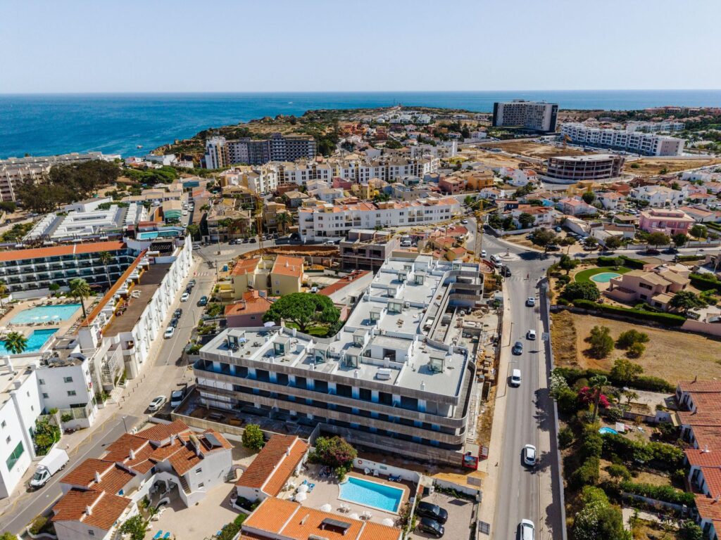 Aerial view of Algarve coastal town with sea and buildings